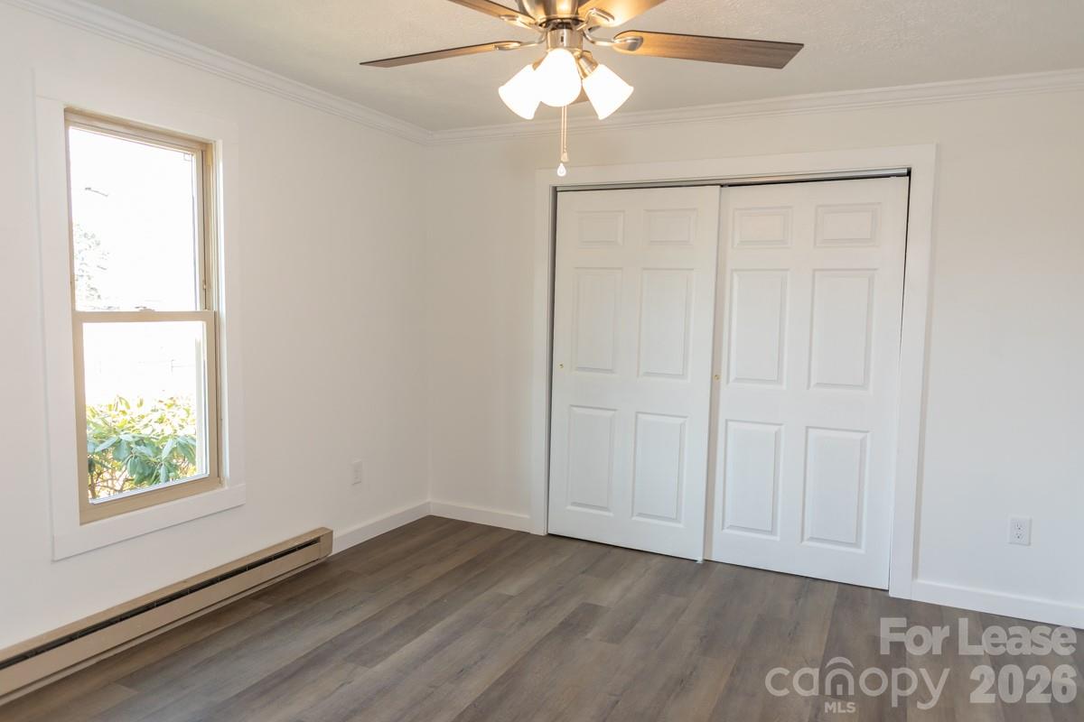 2375 Conley Road Morganton, NC 28655 - Photo 10 of 15 an empty room with wooden floor fan and windows