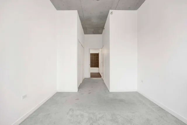 a view of an empty room with windows