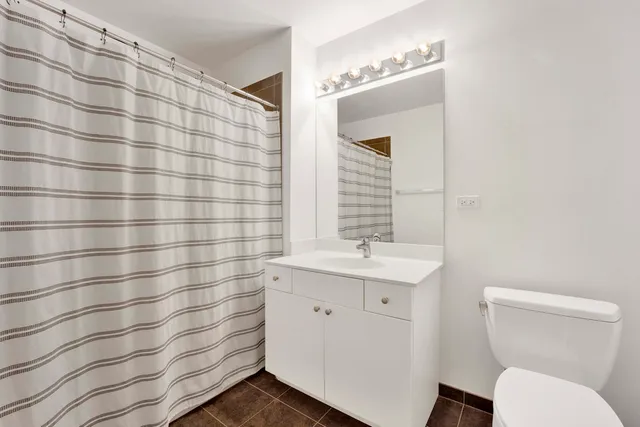 a bathroom with a sink a toilet and mirror