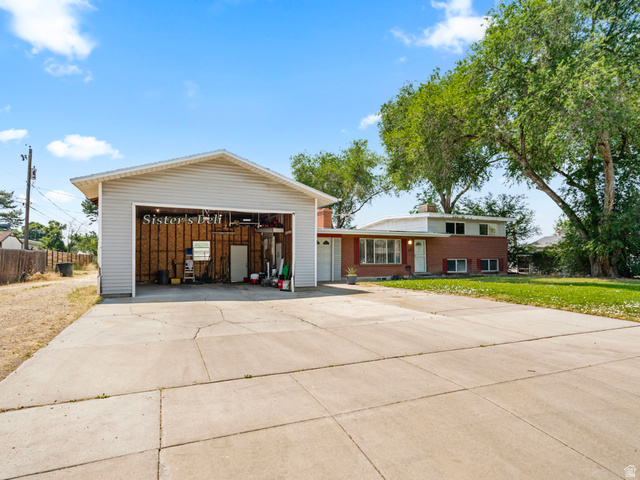 120 Cox Lane Midvale, UT 84047 - Photo 2 of 13 Expansive concrete driveway servicing both the attached garage and the detached open-bay garage