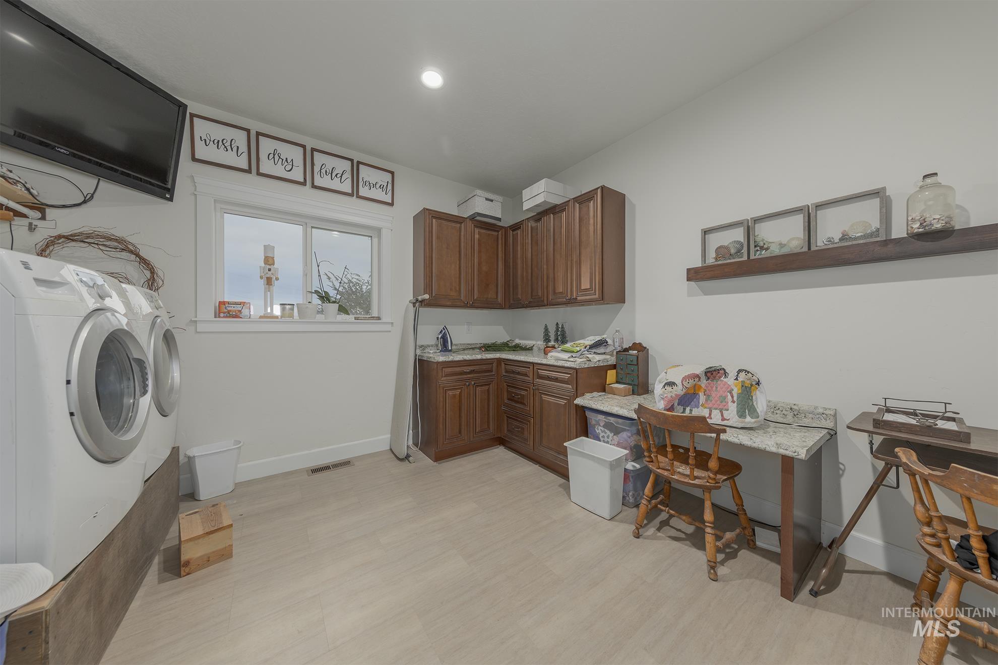 5631 Sunset Road Fruitland, ID 83619 - Photo 19 of 50 Washroom featuring separate washer and dryer, cabinet space, and recessed lighting