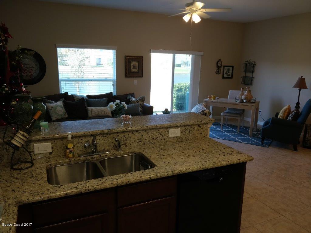 2790 Reston Street, Unit 104 Melbourne, FL 32935 - Photo 12 of 30 a living room with furniture and a flat screen tv