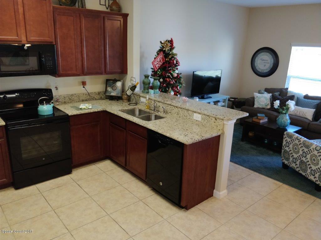 2790 Reston Street, Unit 104 Melbourne, FL 32935 - Photo 13 of 30 a kitchen with a cabinets and appliances