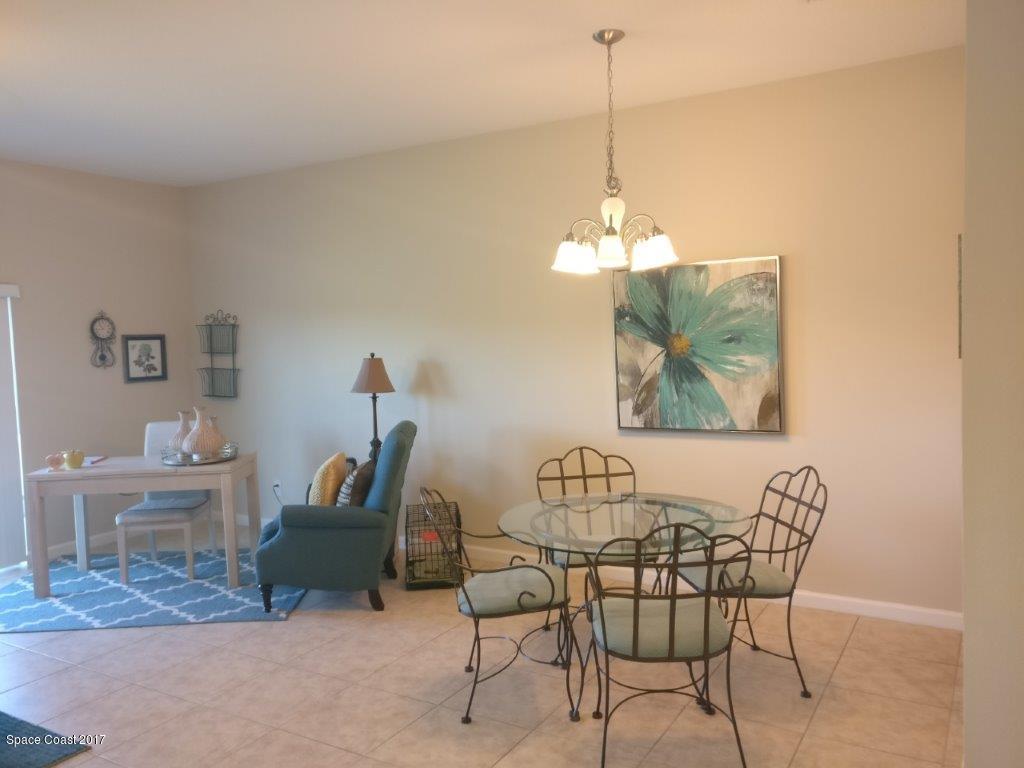 2790 Reston Street, Unit 104 Melbourne, FL 32935 - Photo 15 of 30 a view of a dining room with furniture and chandelier