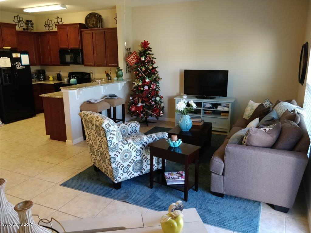 2790 Reston Street, Unit 104 Melbourne, FL 32935 - Photo 16 of 30 a living room with furniture and a flat screen tv