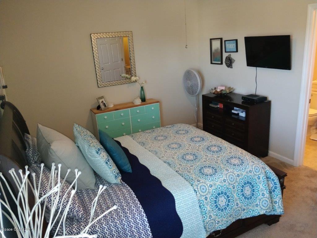 2790 Reston Street, Unit 104 Melbourne, FL 32935 - Photo 20 of 30 a bedroom with a bed and a flat screen tv
