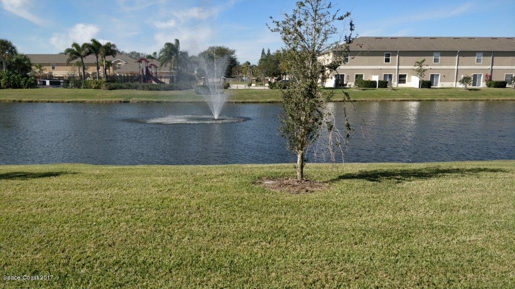 2790 Reston Street, Unit 104 Melbourne, FL 32935 - Photo 3 of 30 a view of a lake with a house in the background