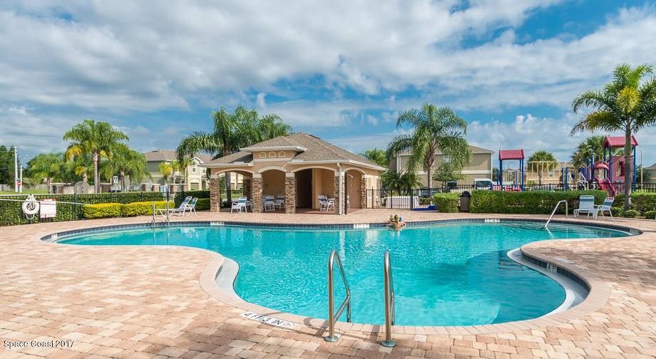 2790 Reston Street, Unit 104 Melbourne, FL 32935 - Photo 25 of 30 a view of a swimming pool with a garden and plants