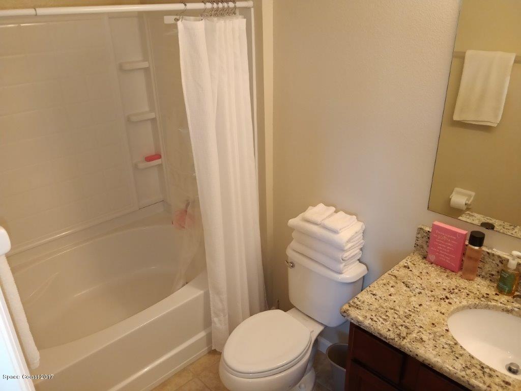 2790 Reston Street, Unit 104 Melbourne, FL 32935 - Photo 27 of 30 a bathroom with a granite countertop toilet sink and bathtub