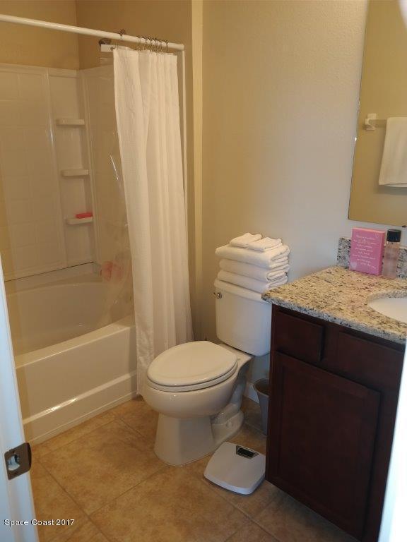 2790 Reston Street, Unit 104 Melbourne, FL 32935 - Photo 28 of 30 a bathroom with a sink a toilet and shower