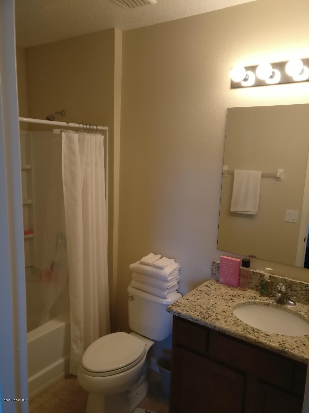 2790 Reston Street, Unit 104 Melbourne, FL 32935 - Photo 30 of 30 a bathroom with a granite countertop sink toilet and shower