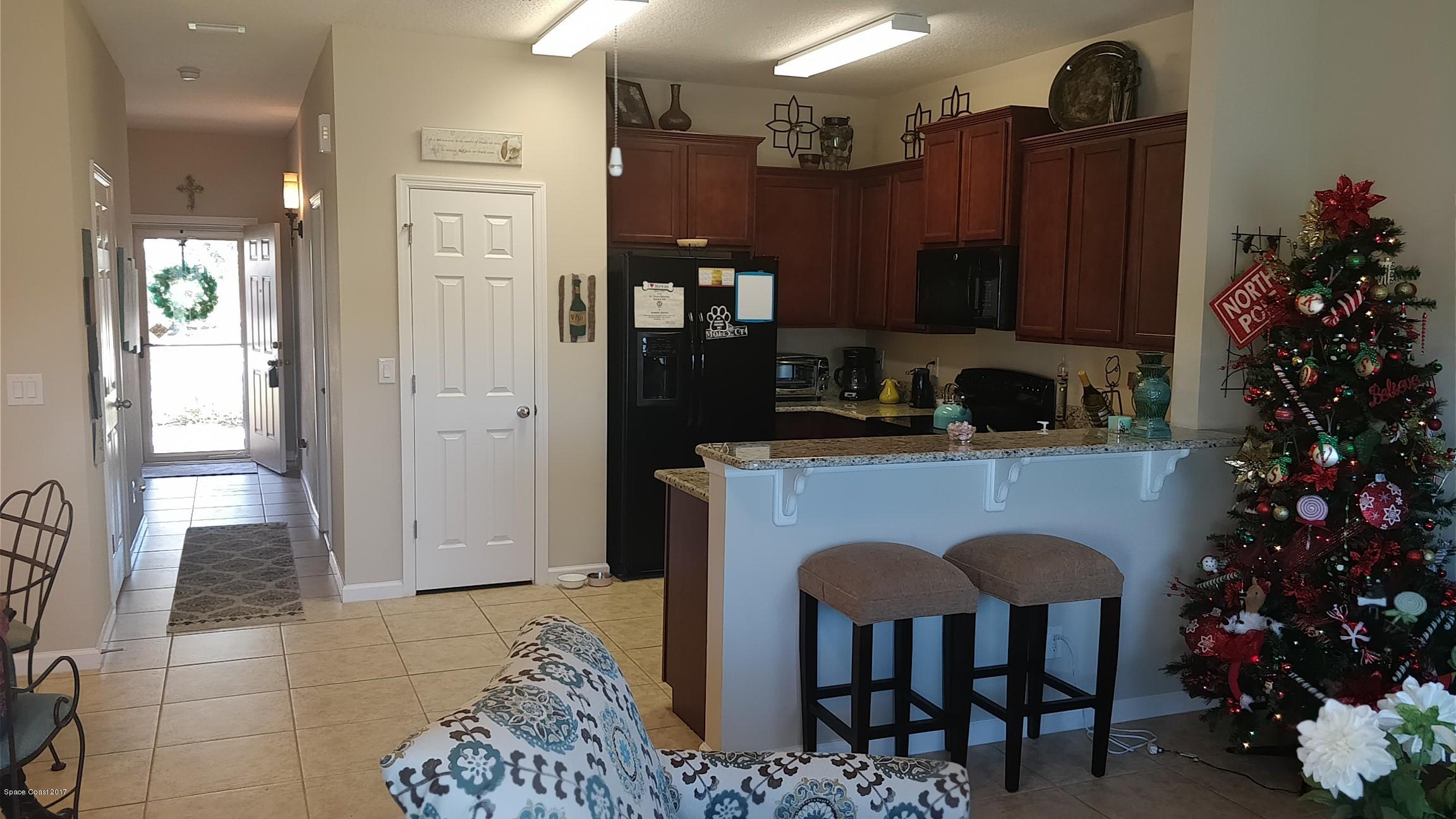 2790 Reston Street, Unit 104 Melbourne, FL 32935 - Photo 8 of 30 a kitchen with a table and chairs