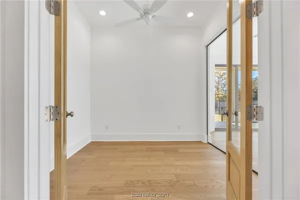 a spacious bathroom with a double vanity sink mirror and bathtub