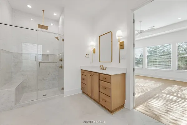 a bathroom with a sink a toilet and shower