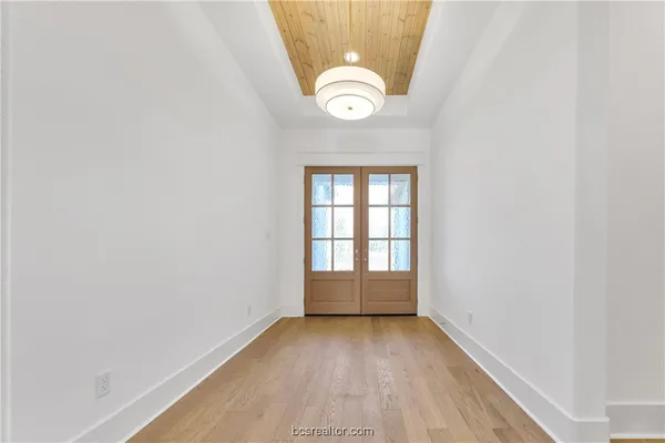 a view of a room with wooden floor and a window