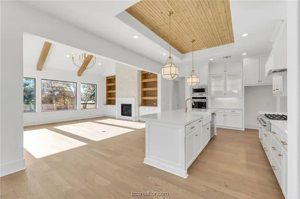 a view of an empty room with a fireplace and a window
