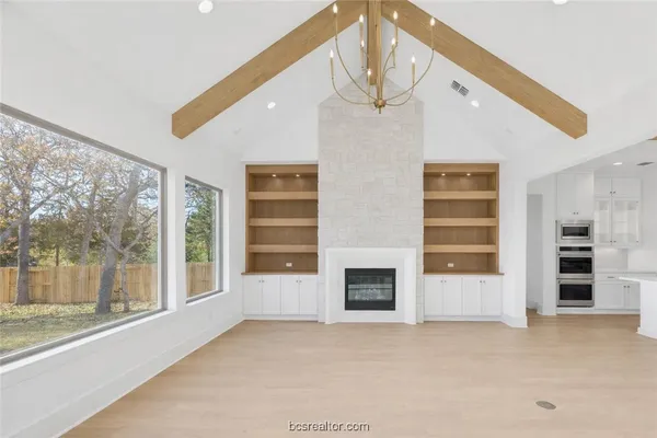 a spacious bedroom with a bed and a fireplace