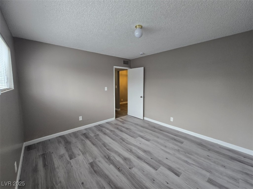 Undisclosed Address Las Vegas, NV 89101 - Photo 4 of 11 Unfurnished room with wood finished floors, basebo