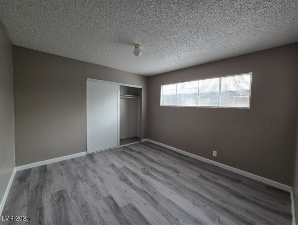 Undisclosed Address Las Vegas, NV 89101 - Photo 5 of 11 Unfurnished bedroom featuring wood finished floors