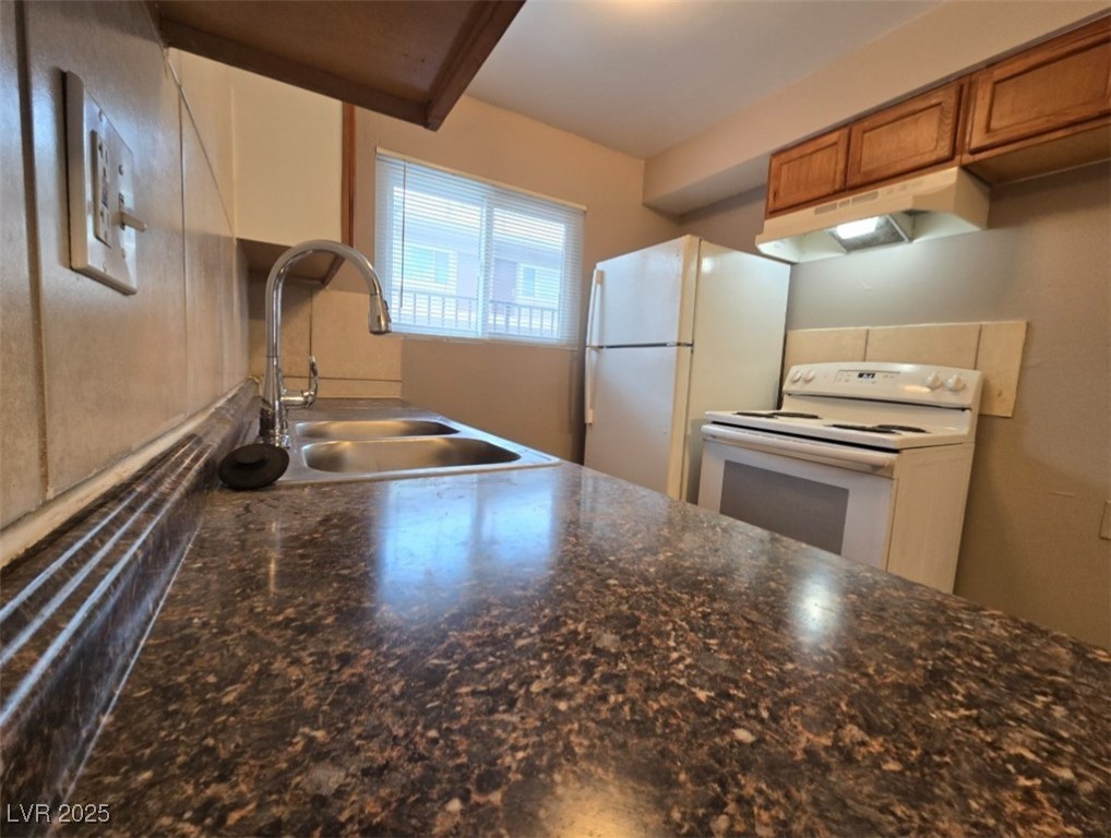 Undisclosed Address Las Vegas, NV 89101 - Photo 7 of 11 Kitchen featuring white appliances, a sink, under