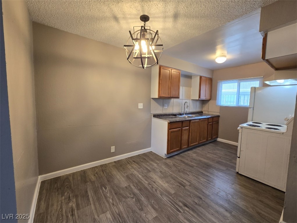 Undisclosed Address Las Vegas, NV 89101 - Photo 9 of 11 Kitchen featuring white appliances, a chandelier,