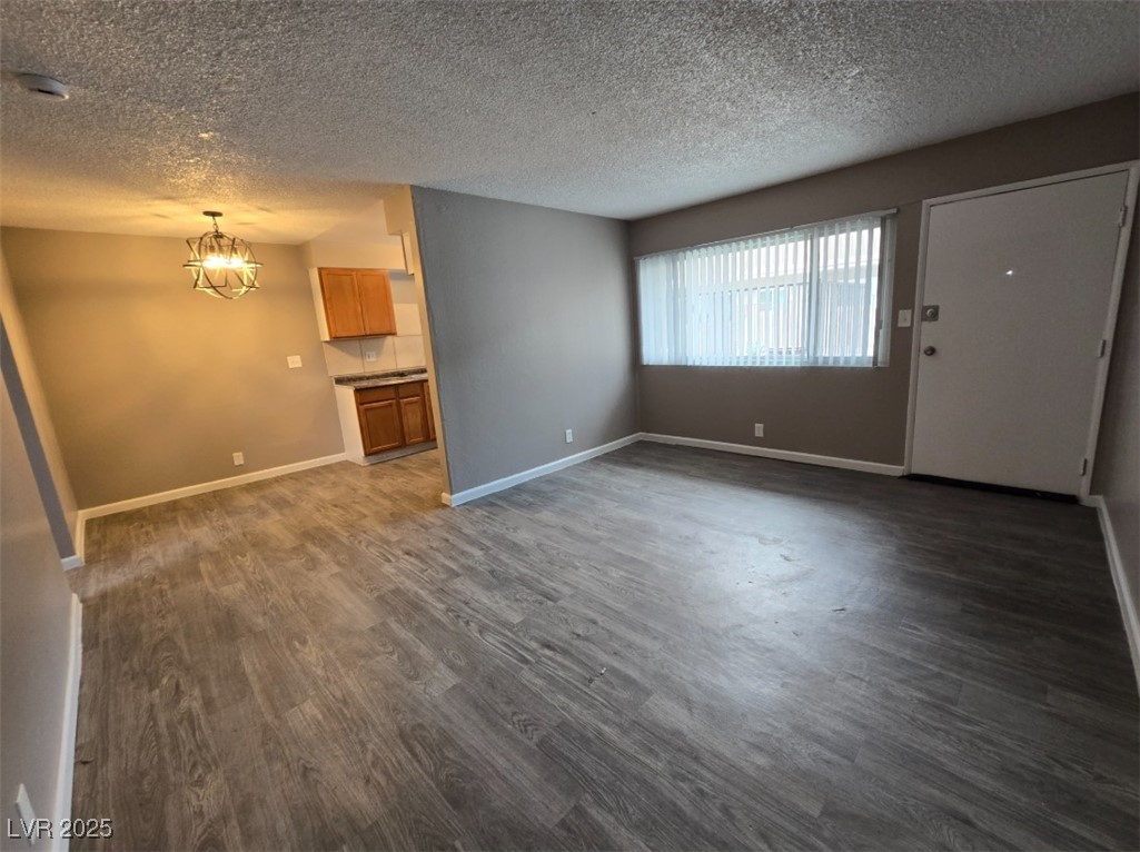Undisclosed Address Las Vegas, NV 89101 - Photo 10 of 11 Unfurnished living room with dark wood finished fl