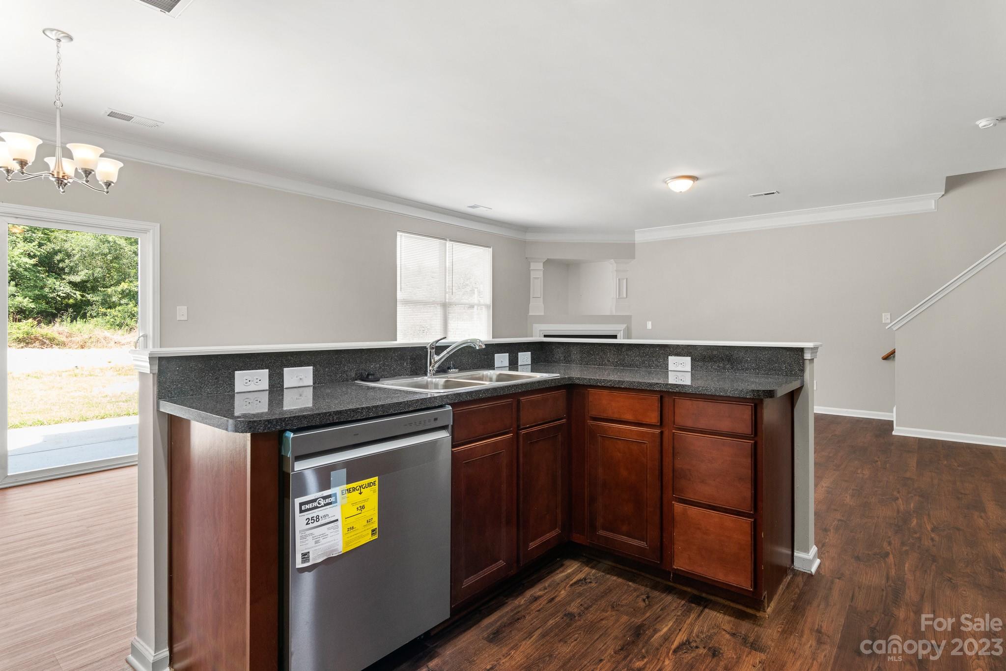 3808 Herkimer Drive Monroe, NC 28110 - Photo 12 of 40 a kitchen with stainless steel appliances granite countertop a sink and wooden cabinets