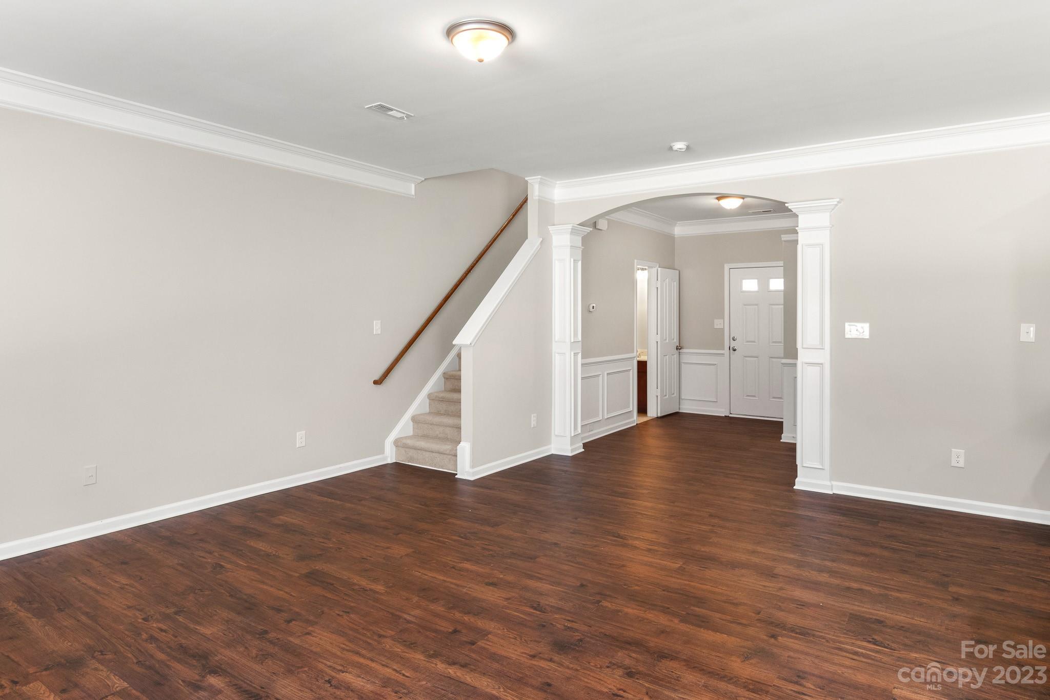 3808 Herkimer Drive Monroe, NC 28110 - Photo 16 of 40 a view of an empty room with wooden floor and stairs