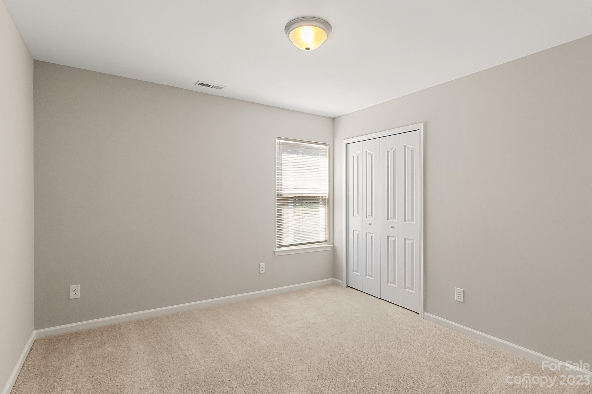 3808 Herkimer Drive Monroe, NC 28110 - Photo 25 of 40 an empty room with windows and closet