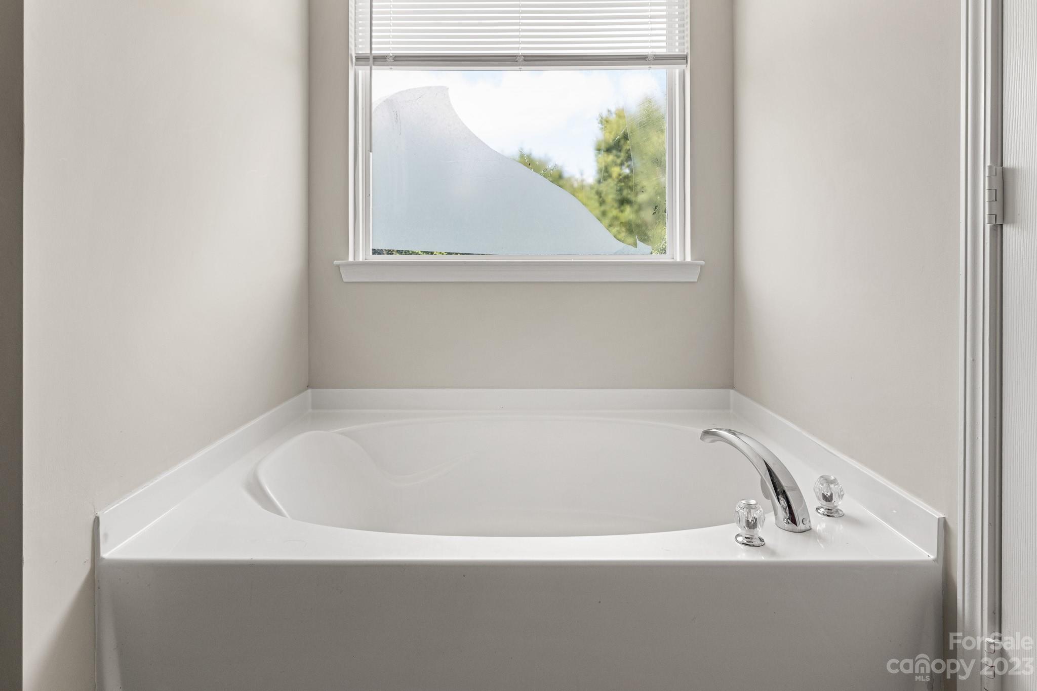 3808 Herkimer Drive Monroe, NC 28110 - Photo 32 of 40 a white bath tub sitting next to a window