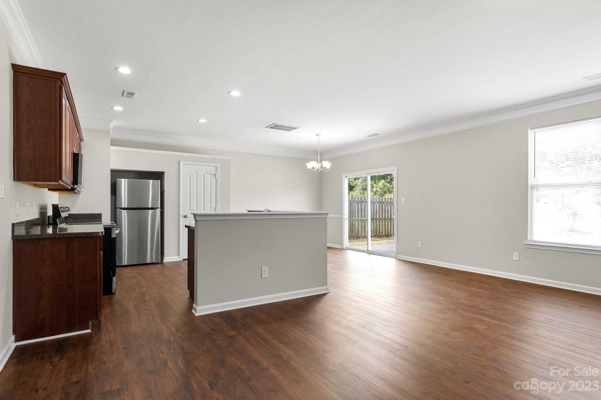 3808 Herkimer Drive Monroe, NC 28110 - Photo 6 of 40 a view of a kitchen with wooden floor and a window