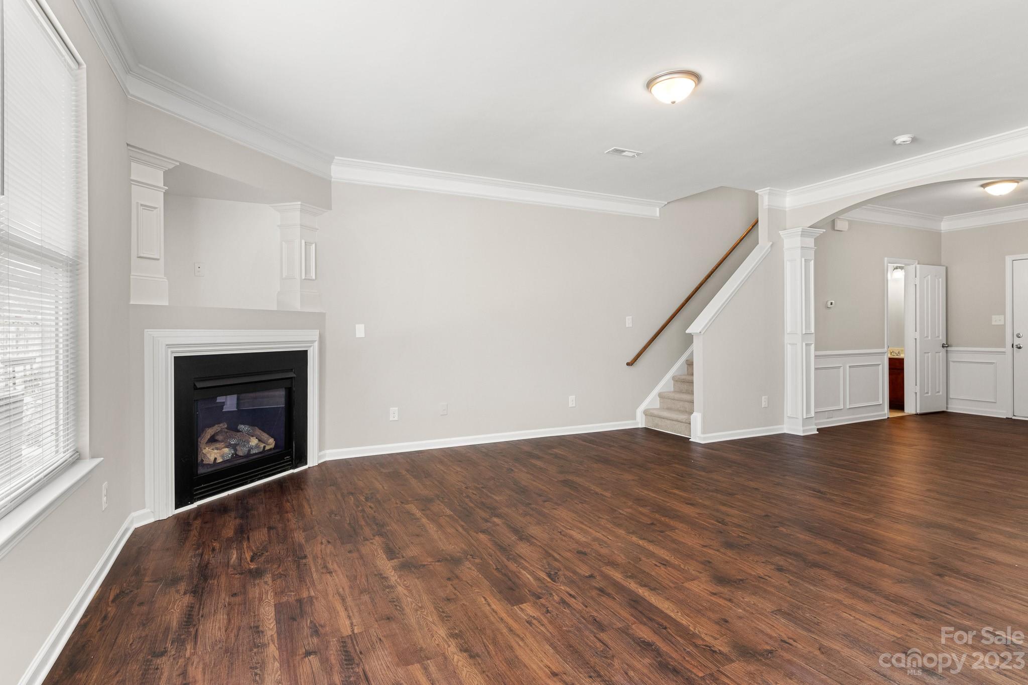 3808 Herkimer Drive Monroe, NC 28110 - Photo 8 of 40 a view of an empty room with wooden floor fireplace and a window