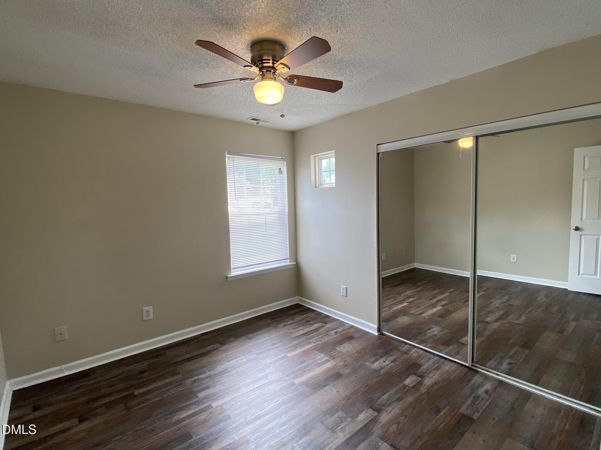 5815 Ricker Road Raleigh, NC 27610 - Photo 14 of 19 an empty room with window and wooden floor