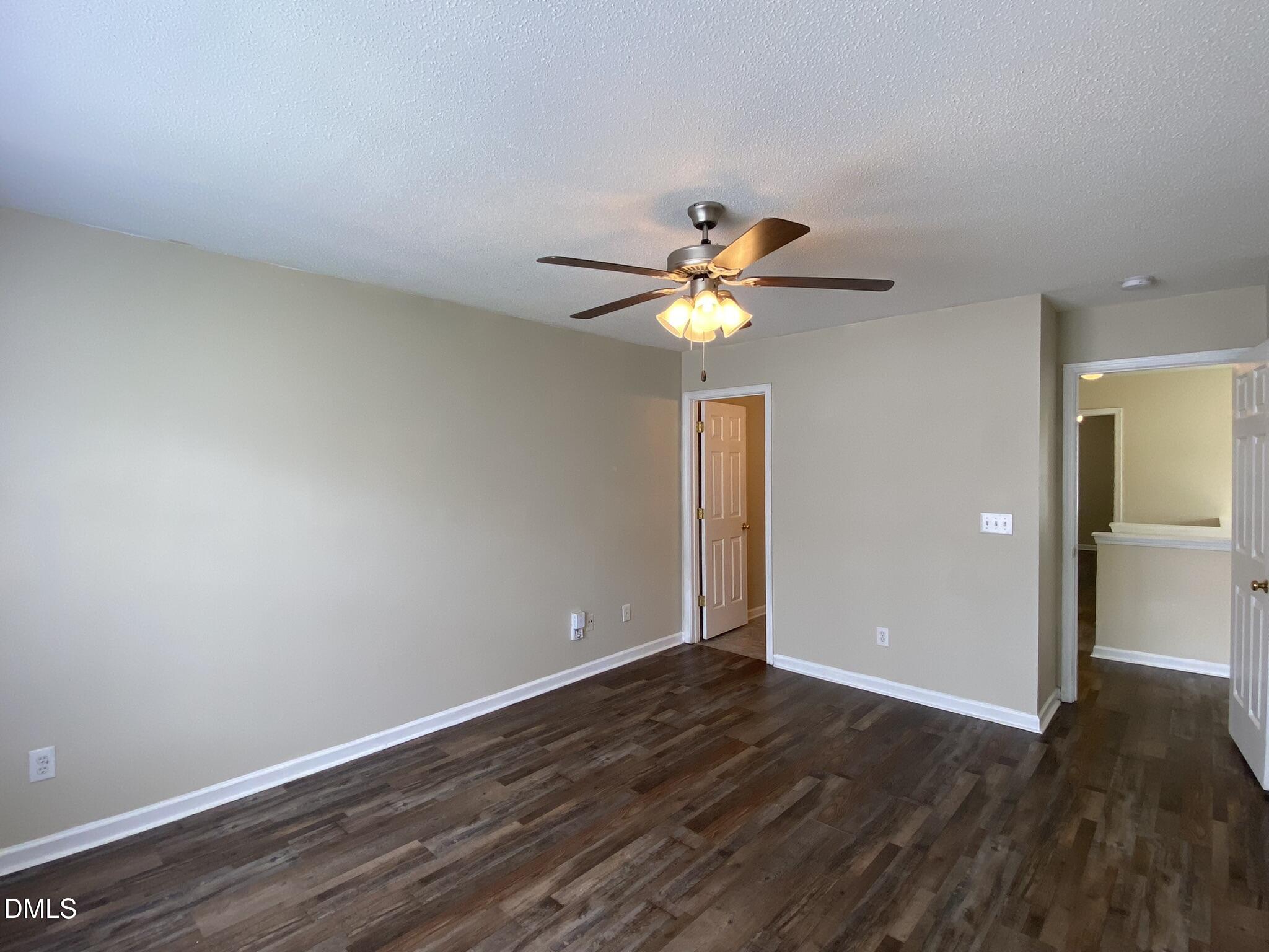 5815 Ricker Road Raleigh, NC 27610 - Photo 18 of 19 a view of an empty room with wooden floor