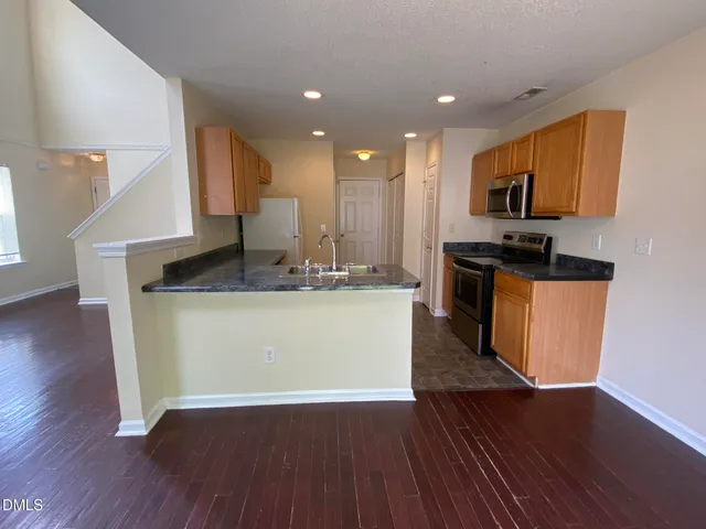a view of kitchen with microwave and wooden floor