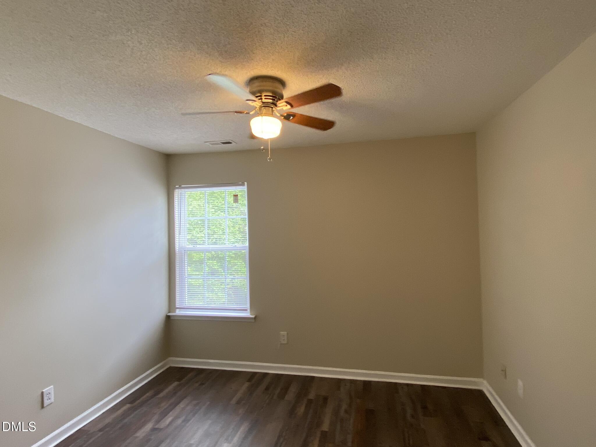 5815 Ricker Road Raleigh, NC 27610 - Photo 10 of 19 a view of a room with a window and a ceiling fan