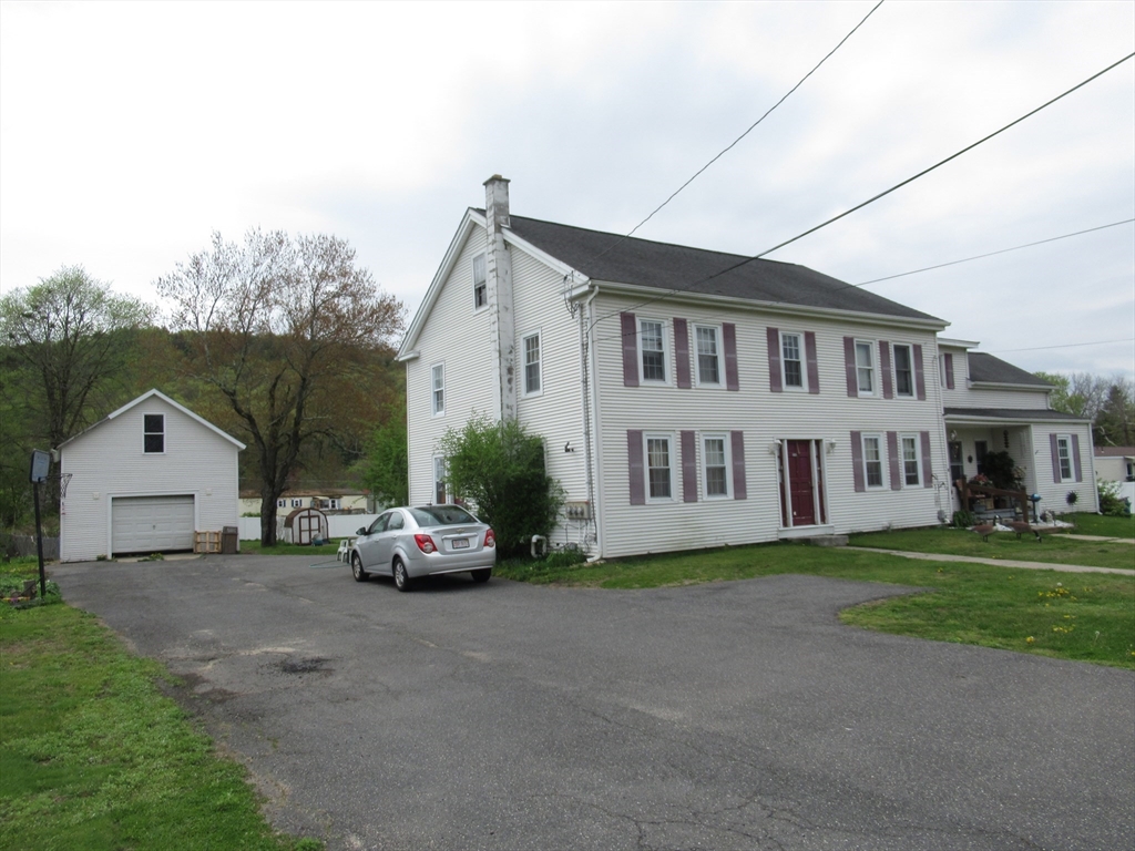 266 Palmer Road Monson, MA 01057 - Photo 2 of 40 a car parked in front of house with a yard