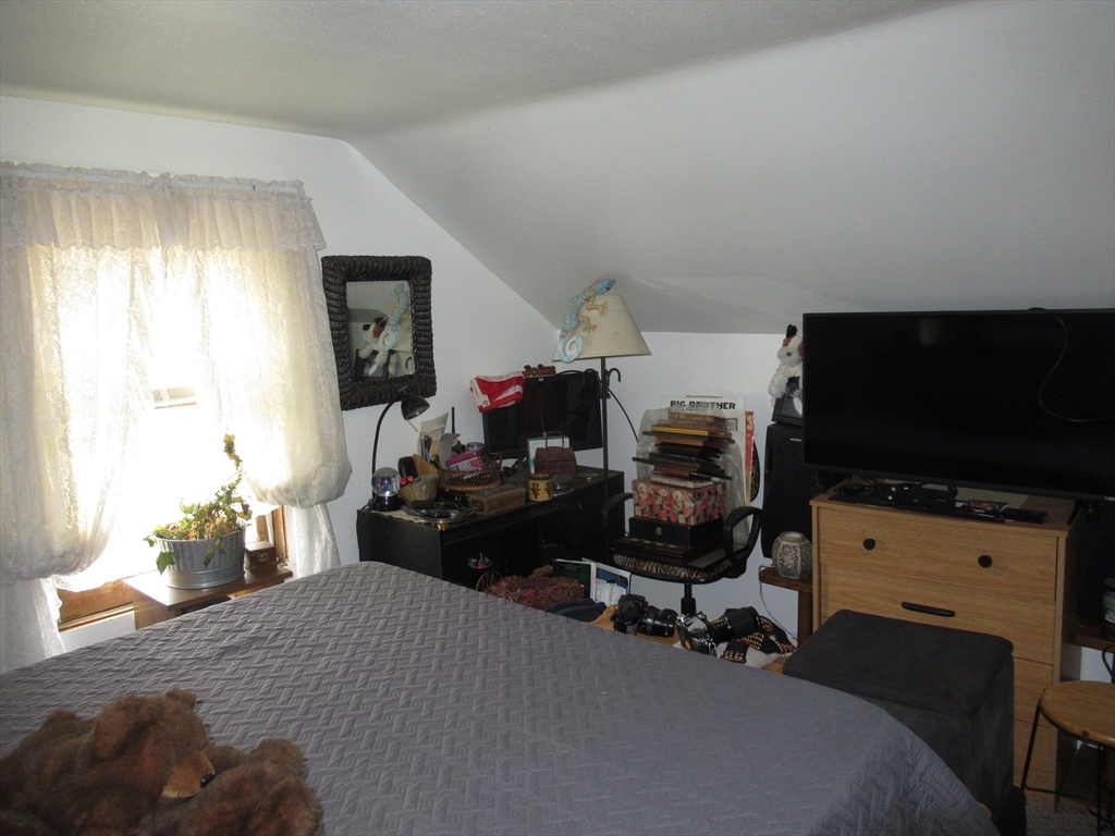 266 Palmer Road Monson, MA 01057 - Photo 24 of 40 a bedroom with a bed and a flat screen tv