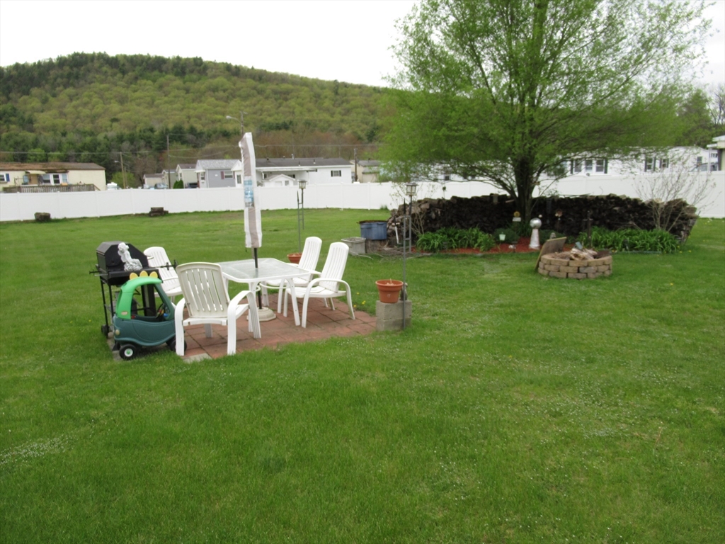 266 Palmer Road Monson, MA 01057 - Photo 33 of 40 a view of a table and chairs in the garden