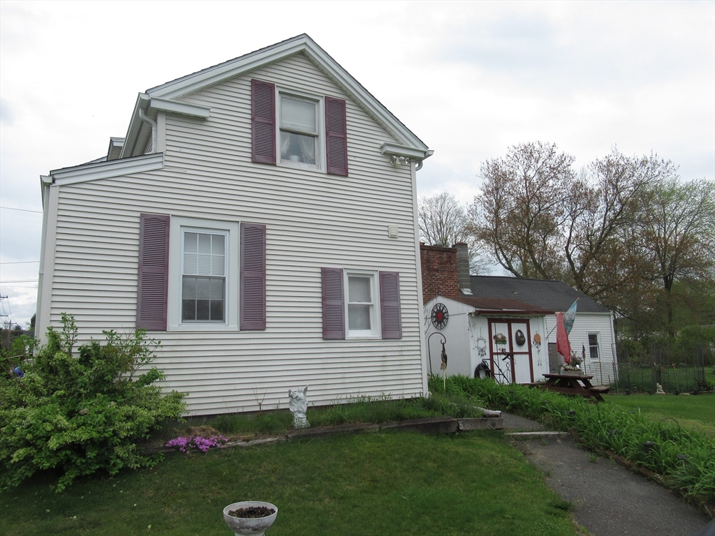 266 Palmer Road Monson, MA 01057 - Photo 34 of 40 a front view of a house with a yard and trees