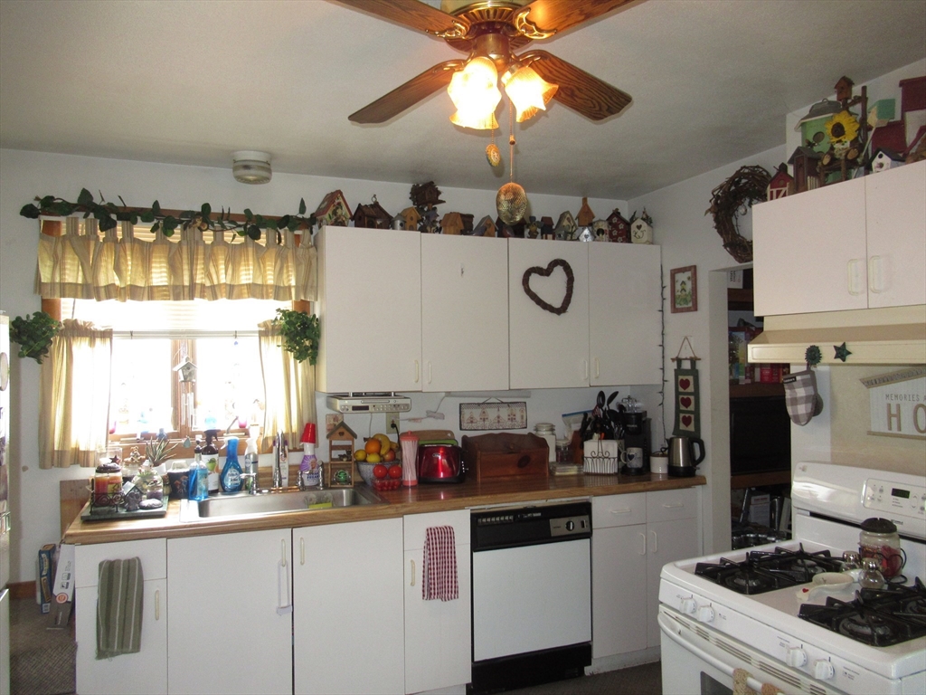 266 Palmer Road Monson, MA 01057 - Photo 4 of 40 a kitchen with a sink a stove and cabinets