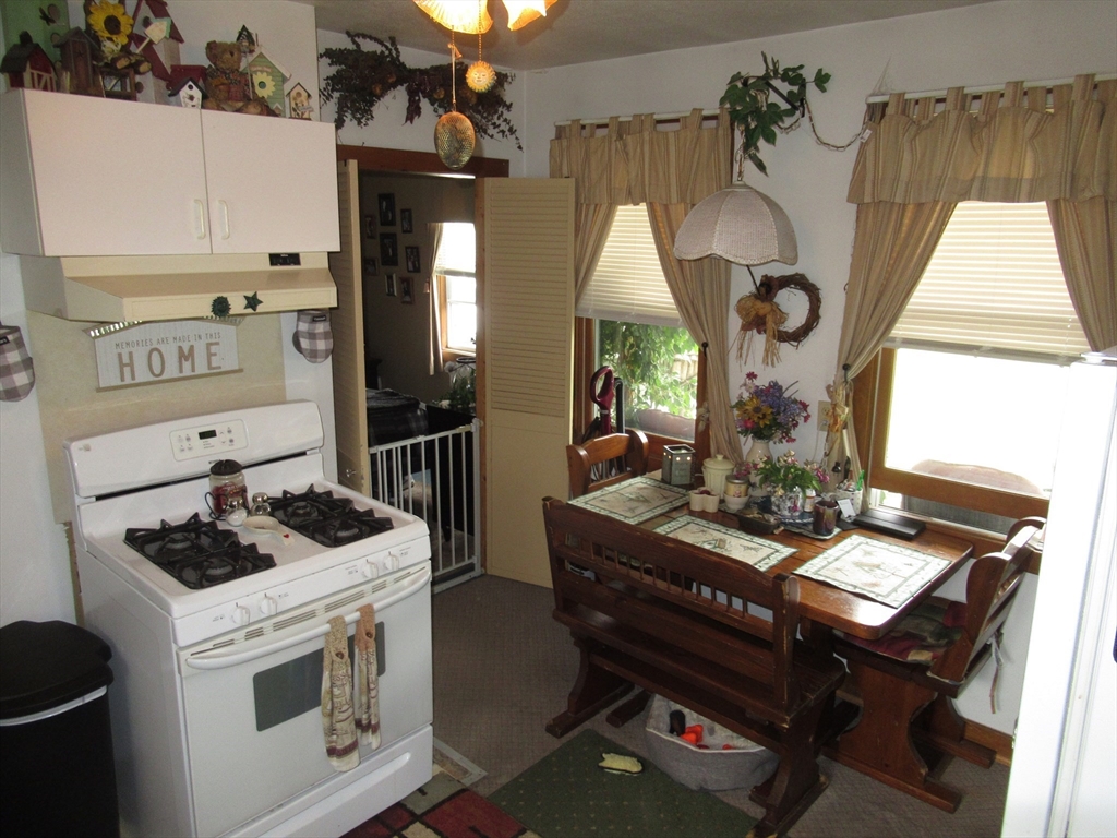 266 Palmer Road Monson, MA 01057 - Photo 6 of 40 a kitchen with a stove cabinets and a table