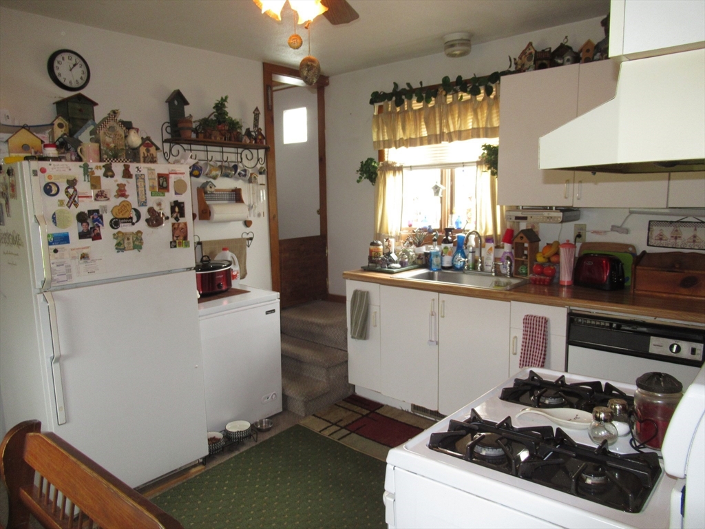 266 Palmer Road Monson, MA 01057 - Photo 8 of 40 a kitchen with a refrigerator and a stove