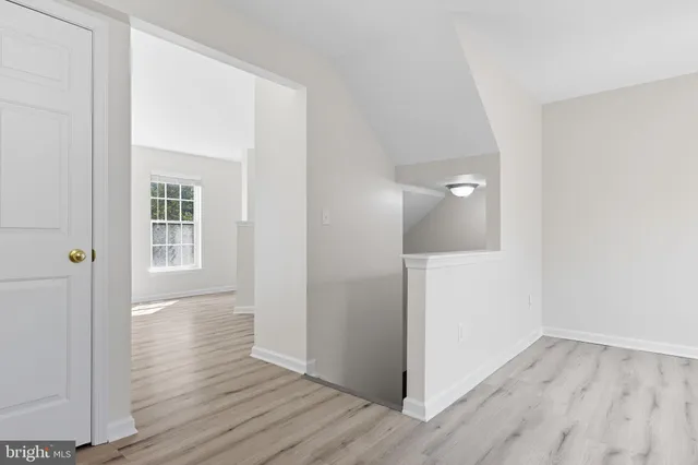 a kitchen with a refrigerator and a stove top oven