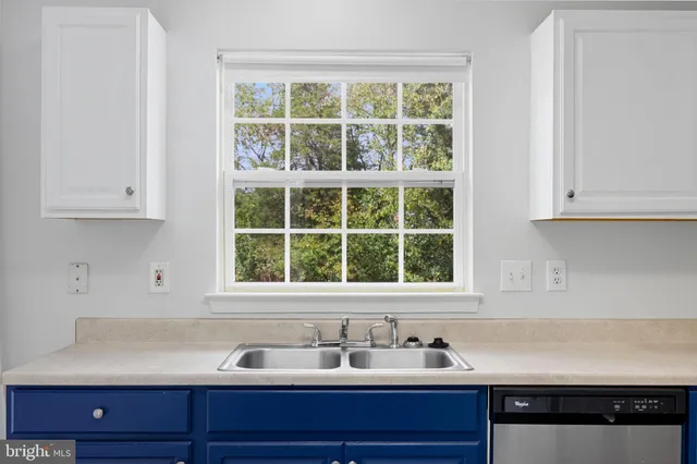 a kitchen with stainless steel appliances a stove microwave and refrigerator