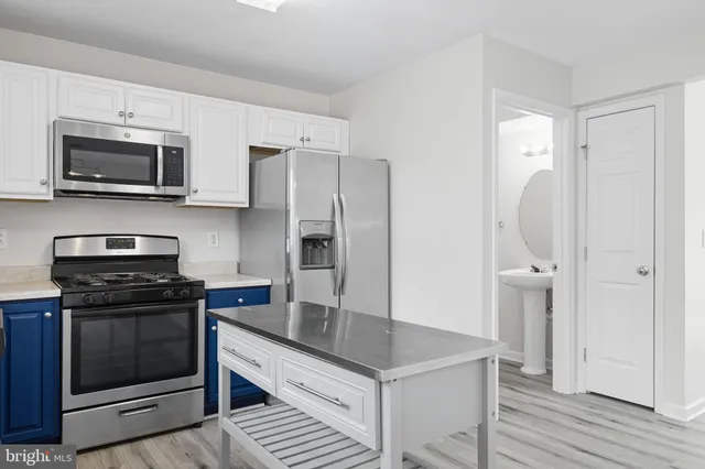 a view of a livingroom with wooden floor and staircase
