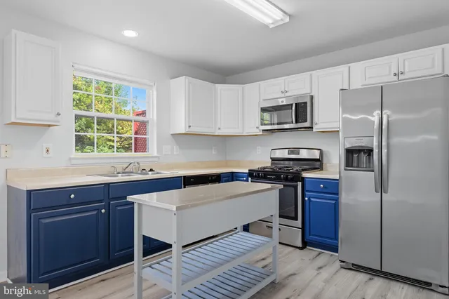 a kitchen with a refrigerator stove and microwave