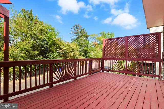 a balcony with wooden floor and fence