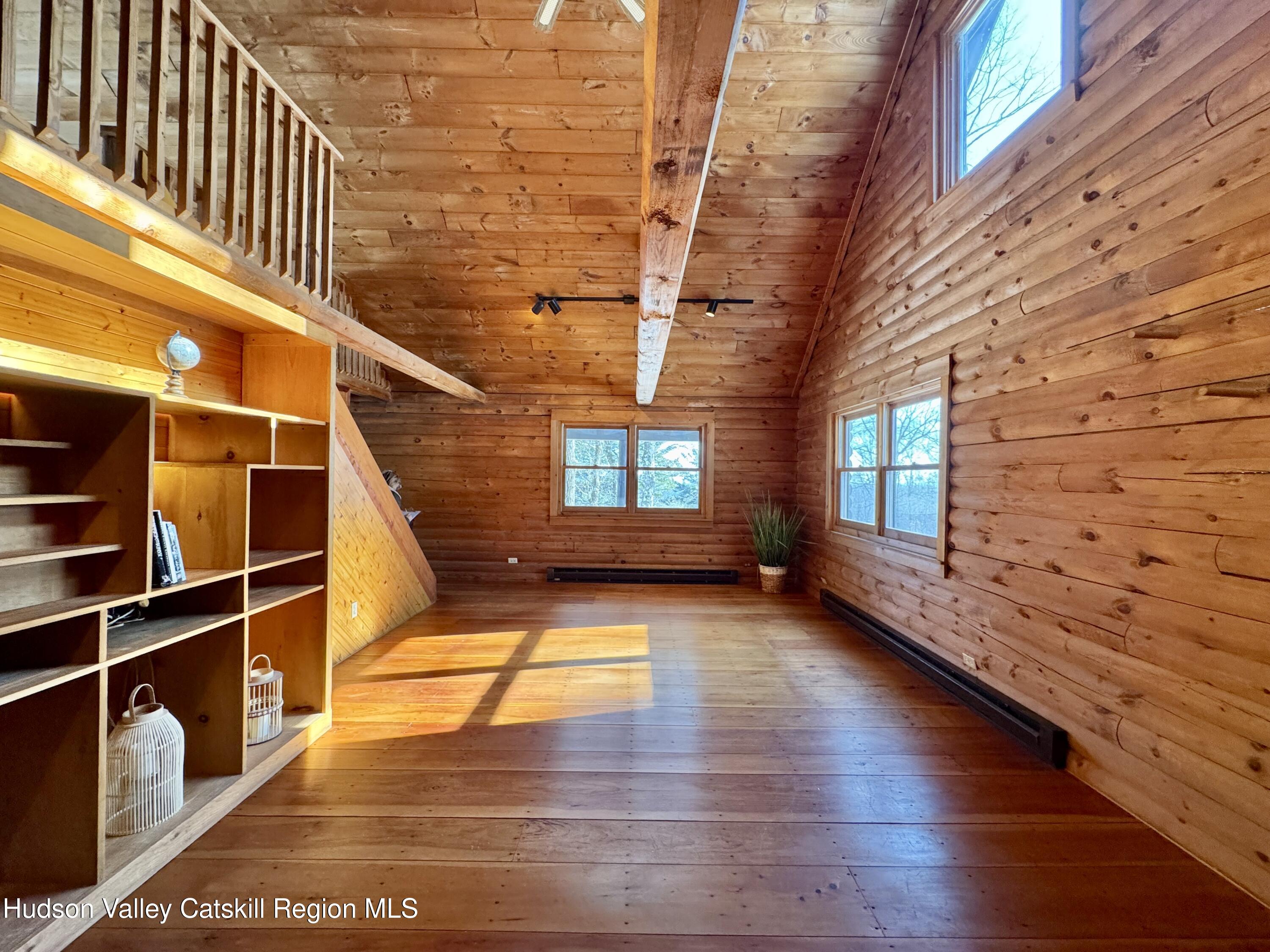 380 Easy Street Catskill, NY 12414 - Photo 16 of 57 a view of an empty room with wooden floor and windows