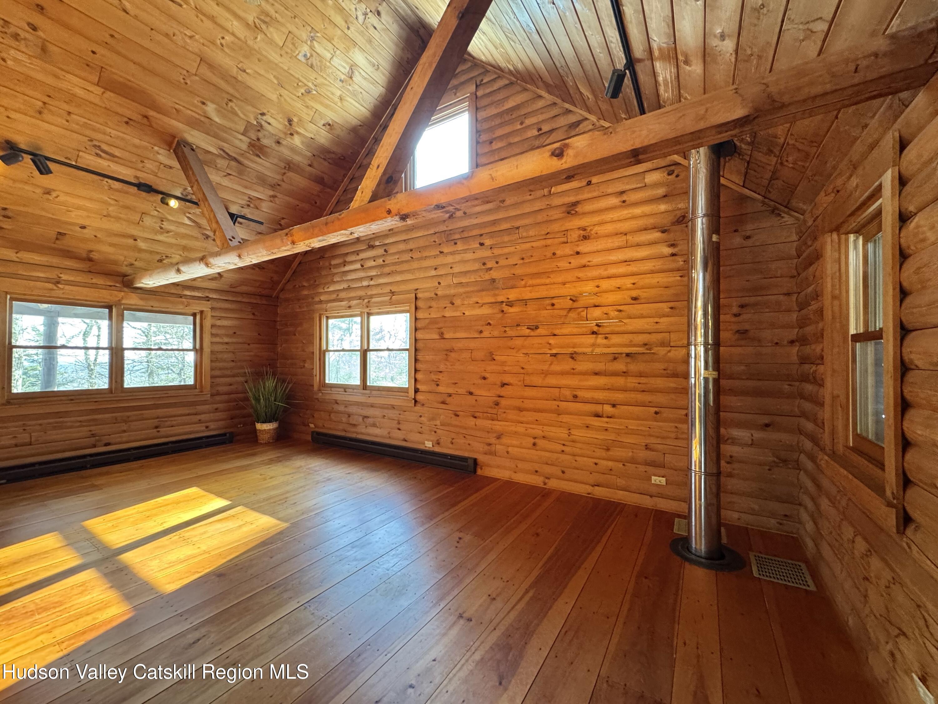 380 Easy Street Catskill, NY 12414 - Photo 19 of 57 a view of empty room with wooden floor and fan